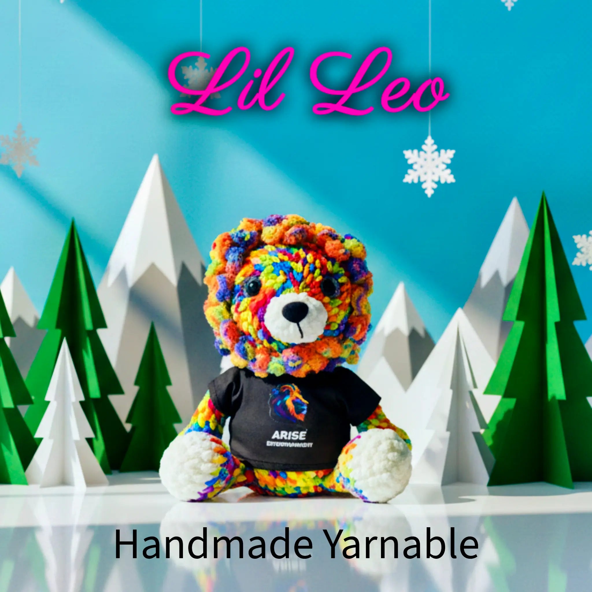 Colorful yarn bear with a black shirt in front of paper trees and mountains, branded 'Lil Leo'.